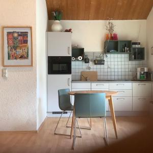 a kitchen with a table and chairs in a room at Landleben - Ferienhaus 1 in Fritzlar +14 photos
