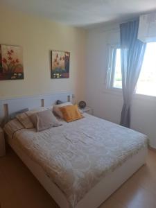 a bedroom with a white bed with a window at Condado de Alhama N478 in Alhama de Murcia +15 photos