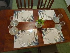 a wooden table with plates and wine glasses on it at Chispa in Santa Rosa