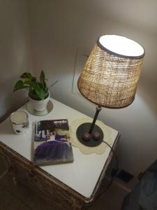 a lamp on a table with a book and a magazine at Chispa in Santa Rosa