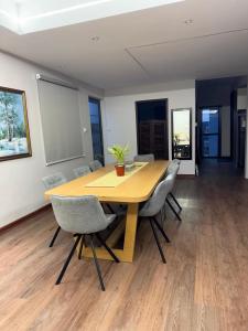 a wooden table in an office with chairs around it at Villa Clair de Lagon in Blue Bay