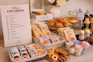 a table topped with different types of bread and pastries at Villa Meraville B&B in Bologna