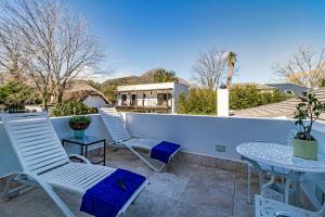 two chairs and a table on a patio at Batavia Boutique Hotel in Stellenbosch