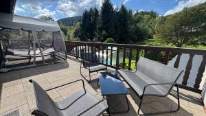 a group of chairs and a gazebo on a balcony at CHATA POD HORAMA in Benecko