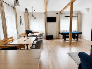 a living room with tables and a pool table at CHATA POD HORAMA in Benecko