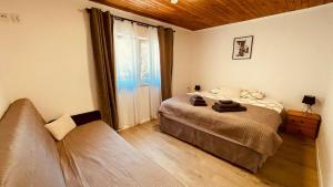 a bedroom with a bed and a large window at CHATA POD HORAMA in Benecko +49 photos