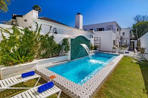 a swimming pool in the backyard of a house at Batavia Boutique Hotel in Stellenbosch
