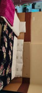 a pile of sheets and pillows on a bed at Friends cottage in Coonoor +4 photos