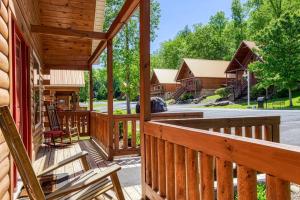 a porch of a log cabin with a kitchen at Cozy Log Cabin, hot tub, pool table, pool access in Gatlinburg