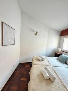 a bedroom with two beds with towels on them at Cascais Historic Villa in Cascais +14 photos