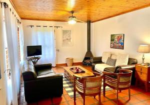 a living room with a couch and a table at Eikelaan Farm Cottages in Tulbagh
