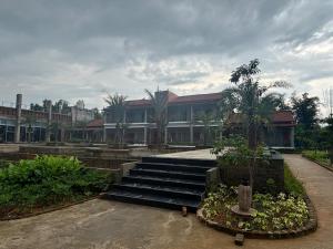 a building with stairs in front of a building at Hide Away Resort in Jhārgrām