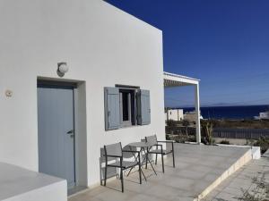 a patio with chairs and a table with a view of the ocean at Villa Ploes in Agios Georgios +57 photos