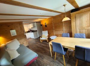 a dining room with a wooden table and chairs at Chalet Sonnenheim mit atemberaubender Aussicht in Adelboden +17 photos