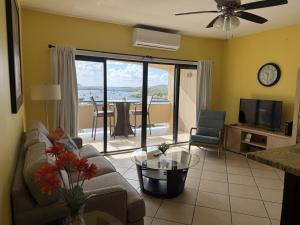 a living room with a couch and a table at Charming 1BR Villa Steps from Red Hook Hotspots in Nazareth