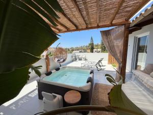 a hot tub on the patio of a house at Arbona Apartment IIΙ - View in Vóroi