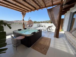 a living room with a hot tub and a couch at Arbona Apartment IIΙ - View in Vóroi
