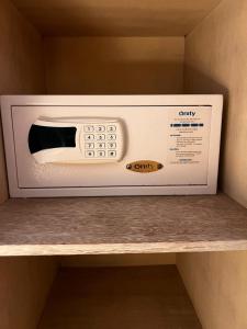 a white microwave sitting on top of a shelf at Hotel Centuria Obelisco in Buenos Aires