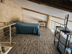 a bedroom with a bed and a table on a balcony at Loft in Aujeurres