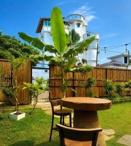 a table and chairs in a yard with a building at 87 Ahangama in Ahangama