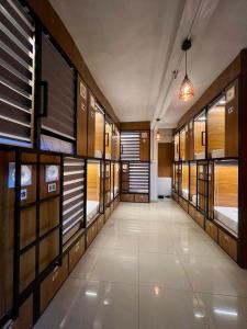 a hallway with many bunk beds in a room at Cozy Rooms & Dormitory in Kozhikode