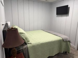 a bedroom with a bed with a television on the wall at Canton River House in Canton
