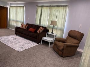 a living room with a couch and a chair at Canton River House in Canton