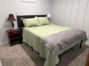 a bedroom with a green bed and a night stand at Canton River House in Canton