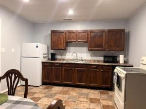 a kitchen with wooden cabinets and a white refrigerator at Canton River House in Canton