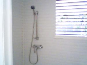 a shower in a bathroom with a shower curtain at Chez Georges in Sainte-Anne