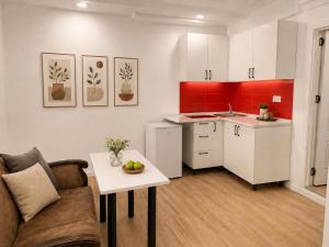 a kitchen with a couch and a table in a room at Senator panoramic Hotel in Baku