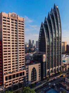 a view of two tall buildings in a city at KL International Hotel in Kuala Lumpur