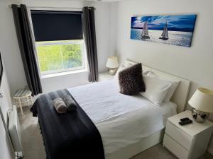 a bedroom with a white bed and a window at Light & Airy flat, Amazing view in Whitefield