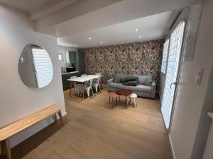 a living room with a couch and a table at Chtî arq in Arques-la-Bataille