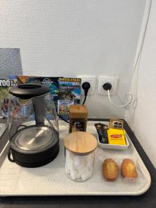 a kitchen counter with a coffee maker and some food at Le Nid Malouin in Saint Malo