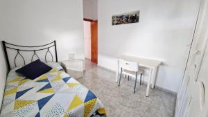 a bedroom with a bed and a table and a desk at Villa Izael AT-BA-00317 in Talavera la Real