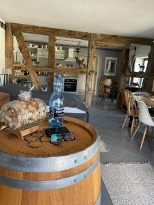 a bottle of alcohol on a barrel in a room at Winnica Bursztynowa in Możdżanowo
