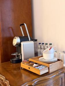 a table with a wooden tray with a cup on it at Islay House in Bridgend