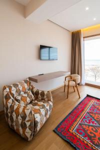 a living room with a couch and a rug at Ustyurt boutique hotel in Aktau