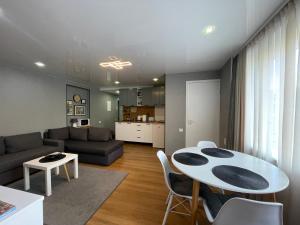 a living room with a table and a couch at Like a home Linda Apartment in Narva