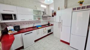 a kitchen with white appliances and a red counter top at Villa Izael AT-BA-00317 in Talavera la Real +17 photos