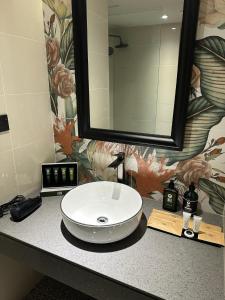 a bathroom sink with a large mirror on a counter at KL International Hotel in Kuala Lumpur +28 photos