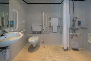 a bathroom with a toilet and a sink at Holiday Inn Express Leeds City Centre by IHG in Leeds +35 photos