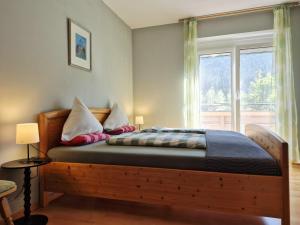 a bedroom with a wooden bed with a window at Alie Gusta in Hermagor +91 photos
