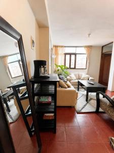 a living room with a couch and a table at Lanni House in Huanchaco