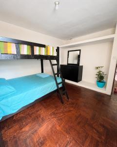 a bedroom with a bunk bed and a mirror at Lanni House in Huanchaco
