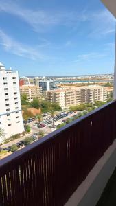 a balcony with a view of a parking lot at Rocha Paradise Apartment in Portimão