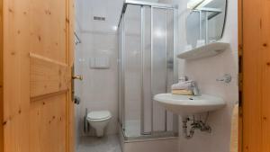 a bathroom with a shower and a sink and a toilet at Apartments B&B Pretermo in Badia +40 photos