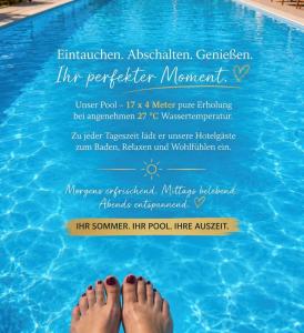 a pair of feet in a swimming pool at HOTEL Jerolitsch in Krumpendorf am Wörthersee +11 photos