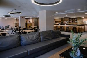 a living room with a couch and tables and a bar at Cal Ruiz in Pas de la Casa